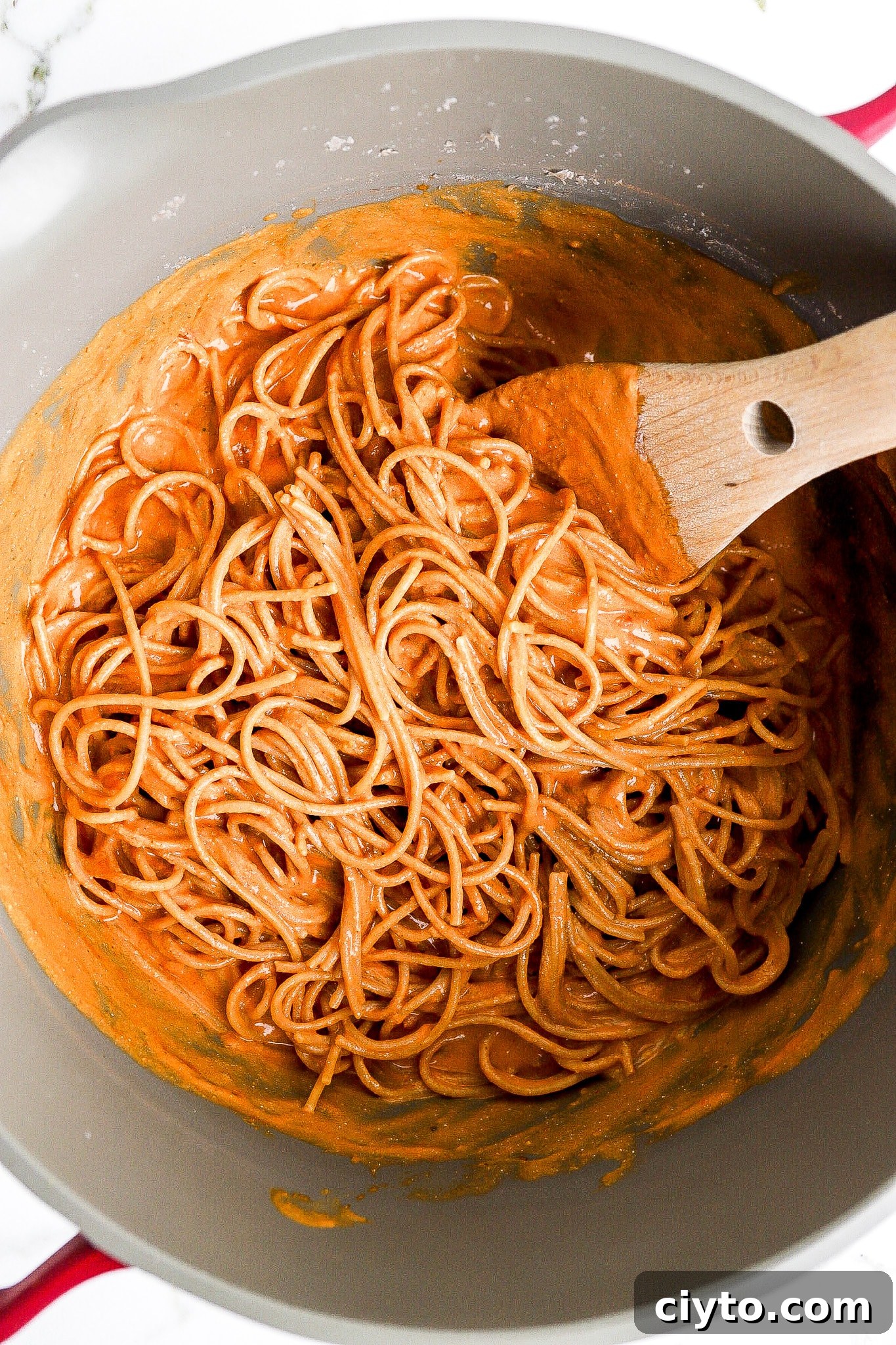 Spaghetti noodles with red sauce in a pot.