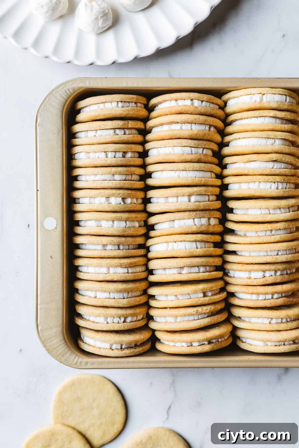 A gold pan with rows of Golden Oreos stuffed with vanilla creme filling.