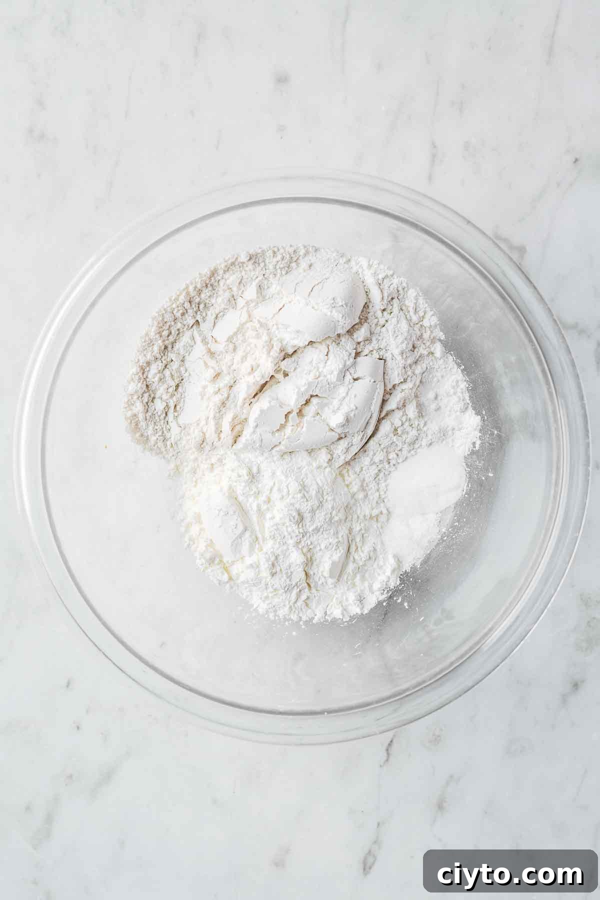 Dry ingredients in a glass mixing bowl.