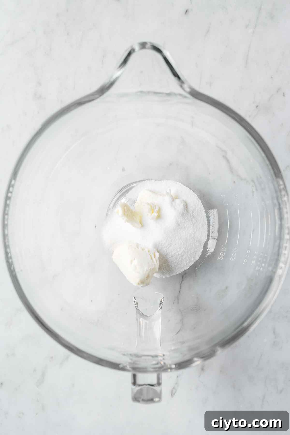 Shortening and sugar in a glass mixing bowl.