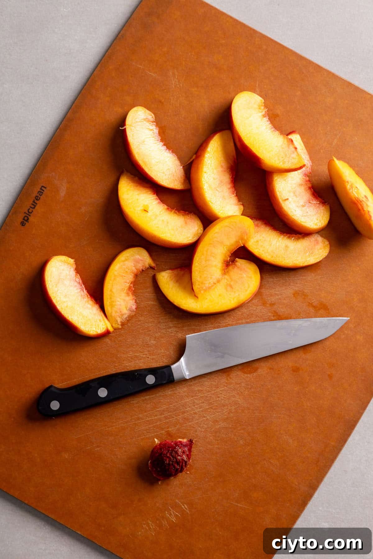 Arugula and Burrata Salad Recipe with Lemon Vinaigrette 6 Peaches sliced with a small knife on a cutting board.