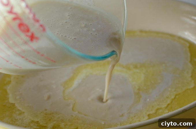 Pouring the batter evenly over the melted butter