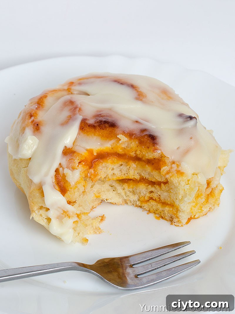 Pumpkin Cinnamon Rolls With Cream Cheese Frosting - served on the plate