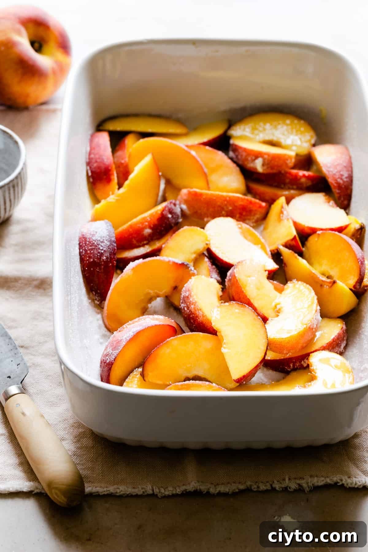 sliced peaches in a baking dish
