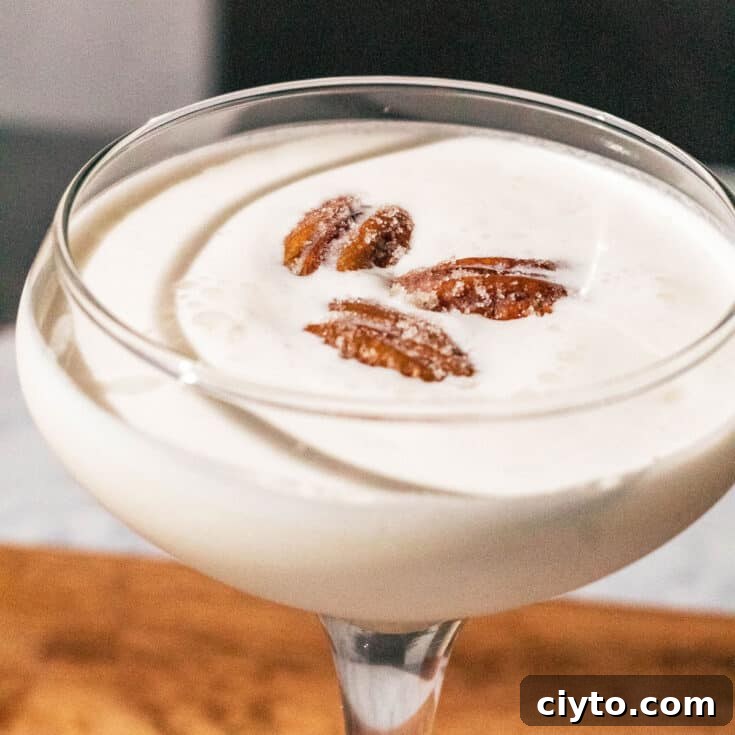A pecan pie martini garnished with three pecans.
