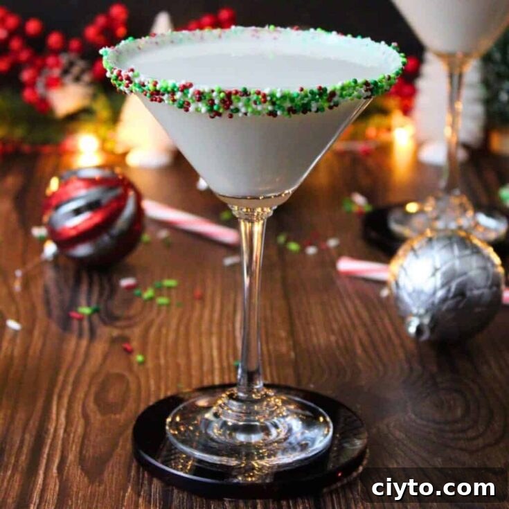 A white sugar cookie martini with a green sprinkle rim.