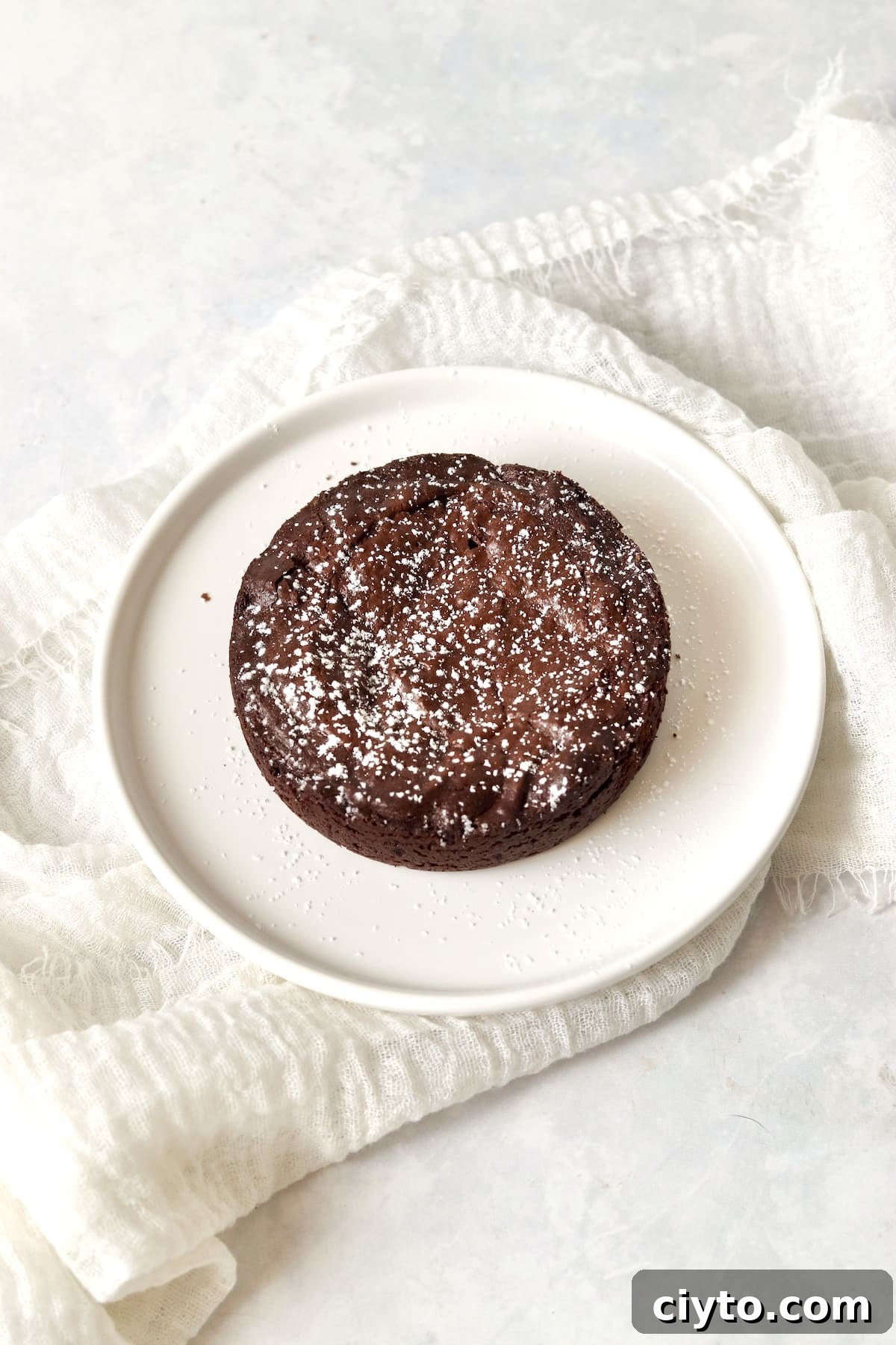 Single serve fudgy brownie on a plate.