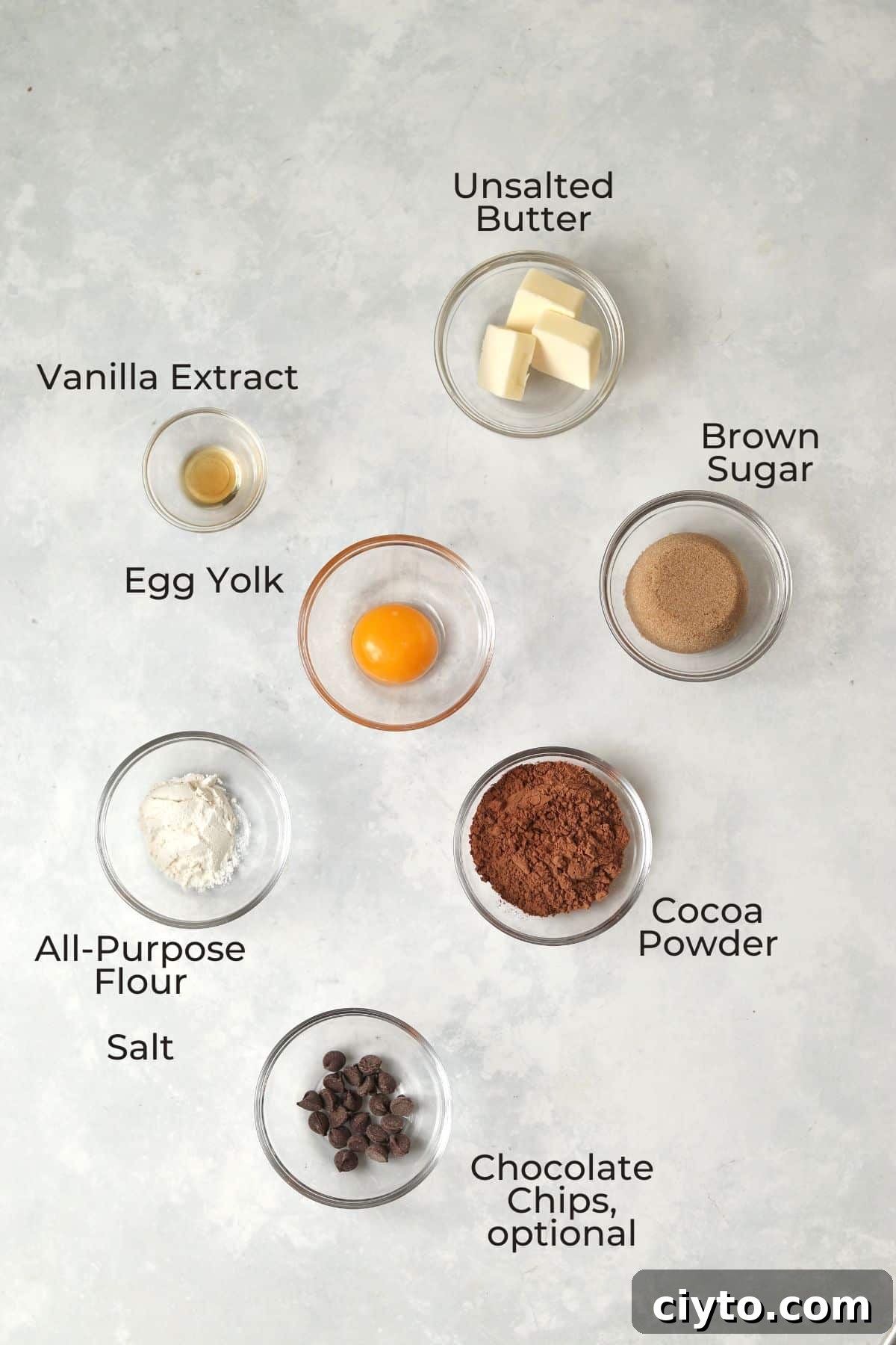 Single serve brownie ingredients in small glass prep bowls.