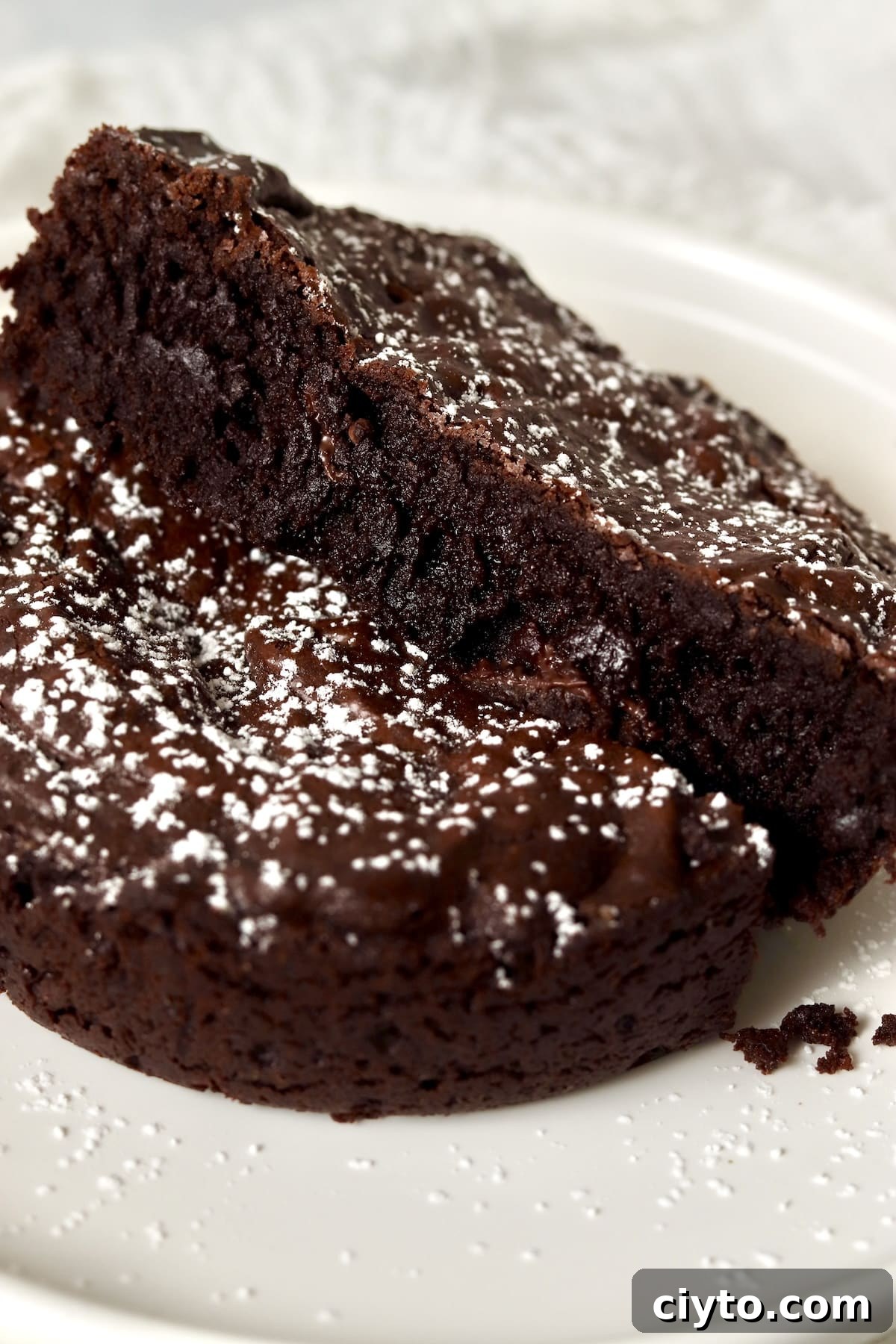 Single serve brownie cut in half to show fudgy inside.