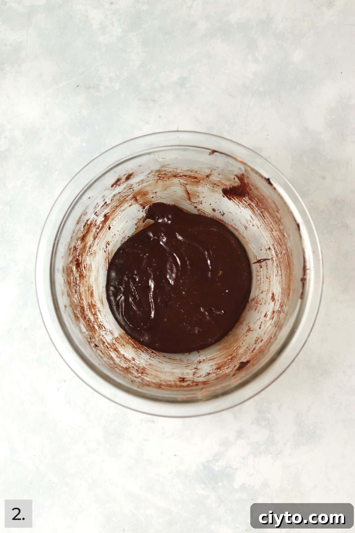 Small batch of brownie batter in a glass bowl.