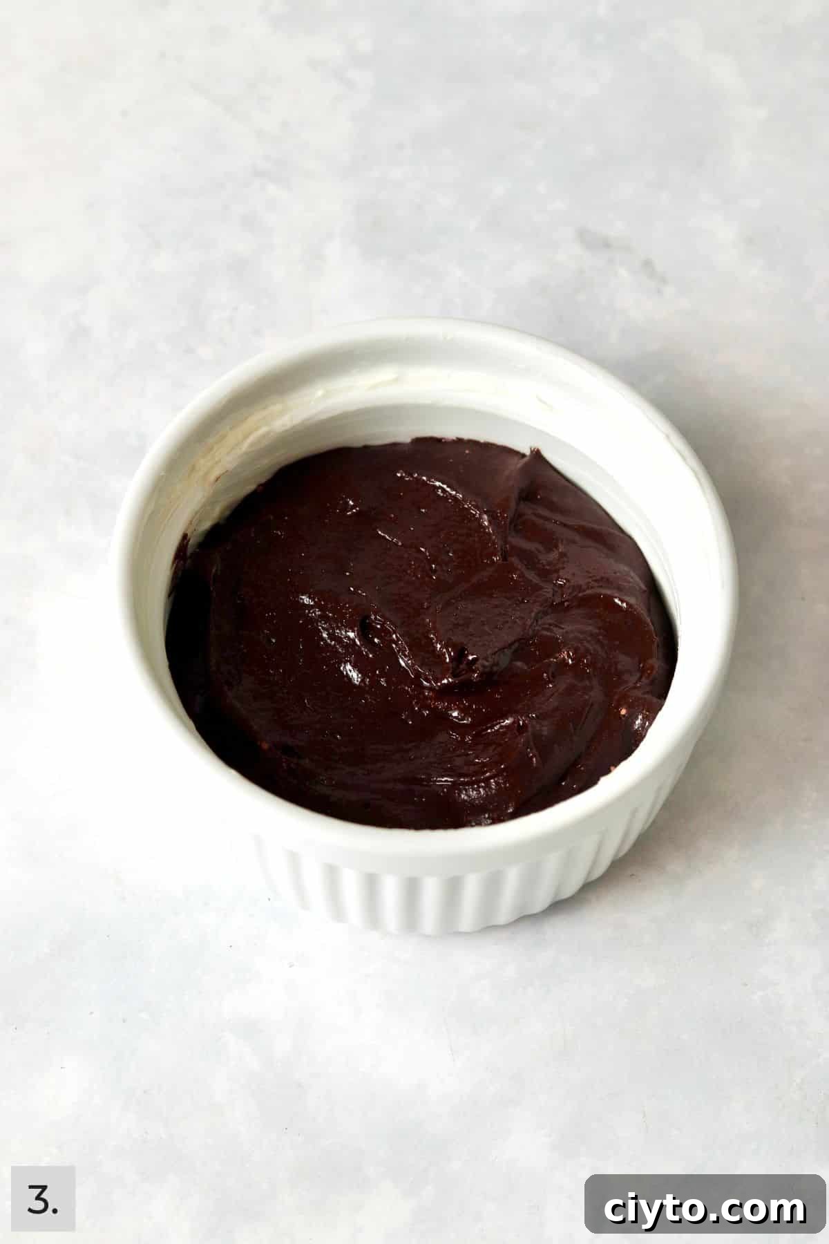Unbaked single serve brownie in a ramekin.