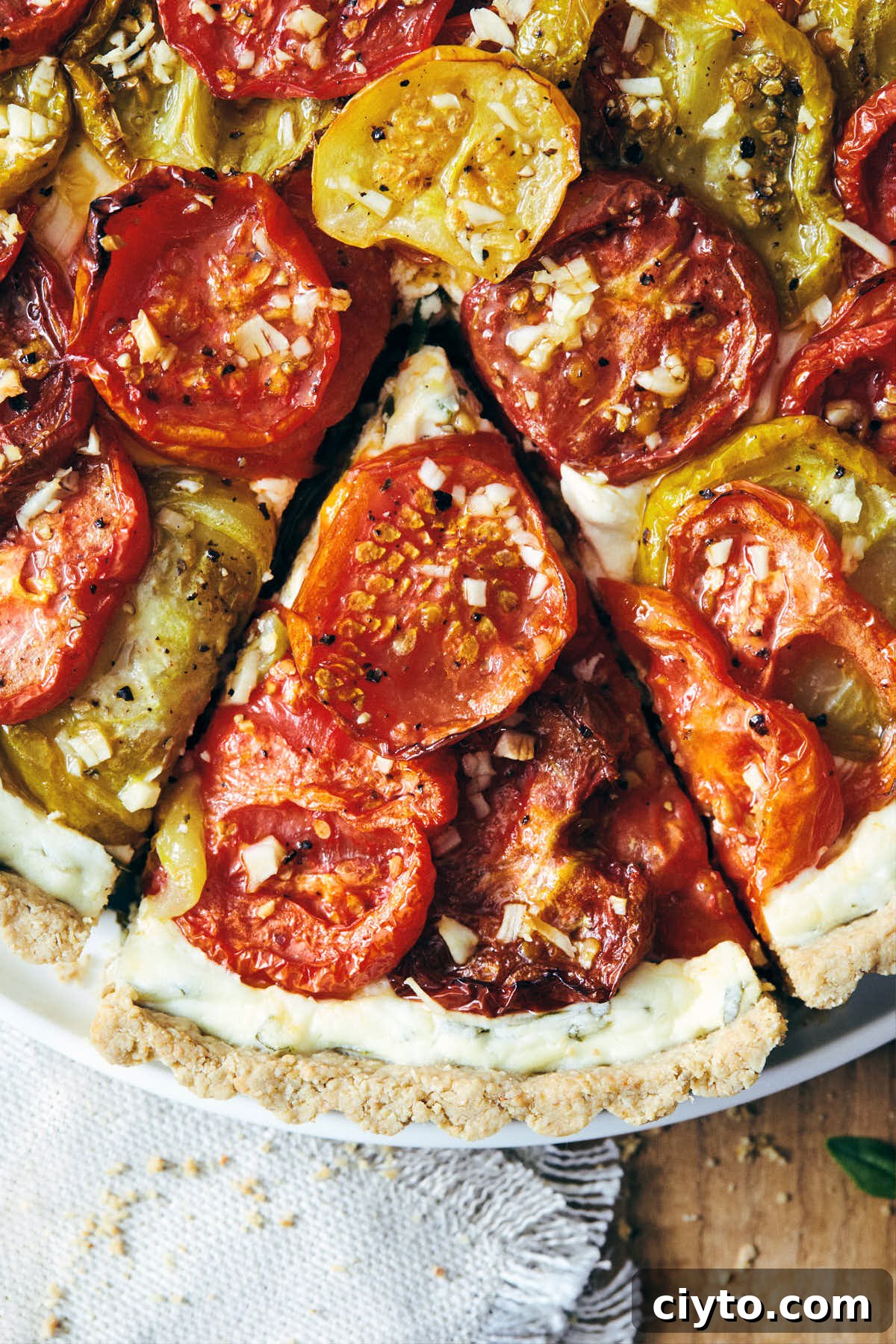 Heirloom tomato tart fresh out of the oven with a slice cut out