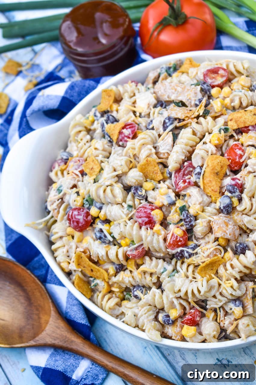 barbecue chicken pasta salad in a large white serving bowl