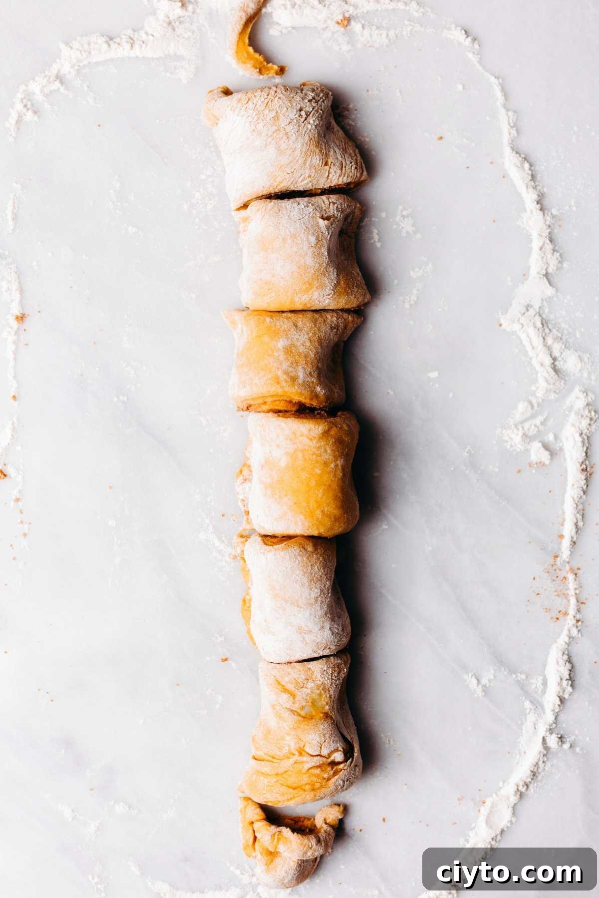 Dough sliced into six rolls.