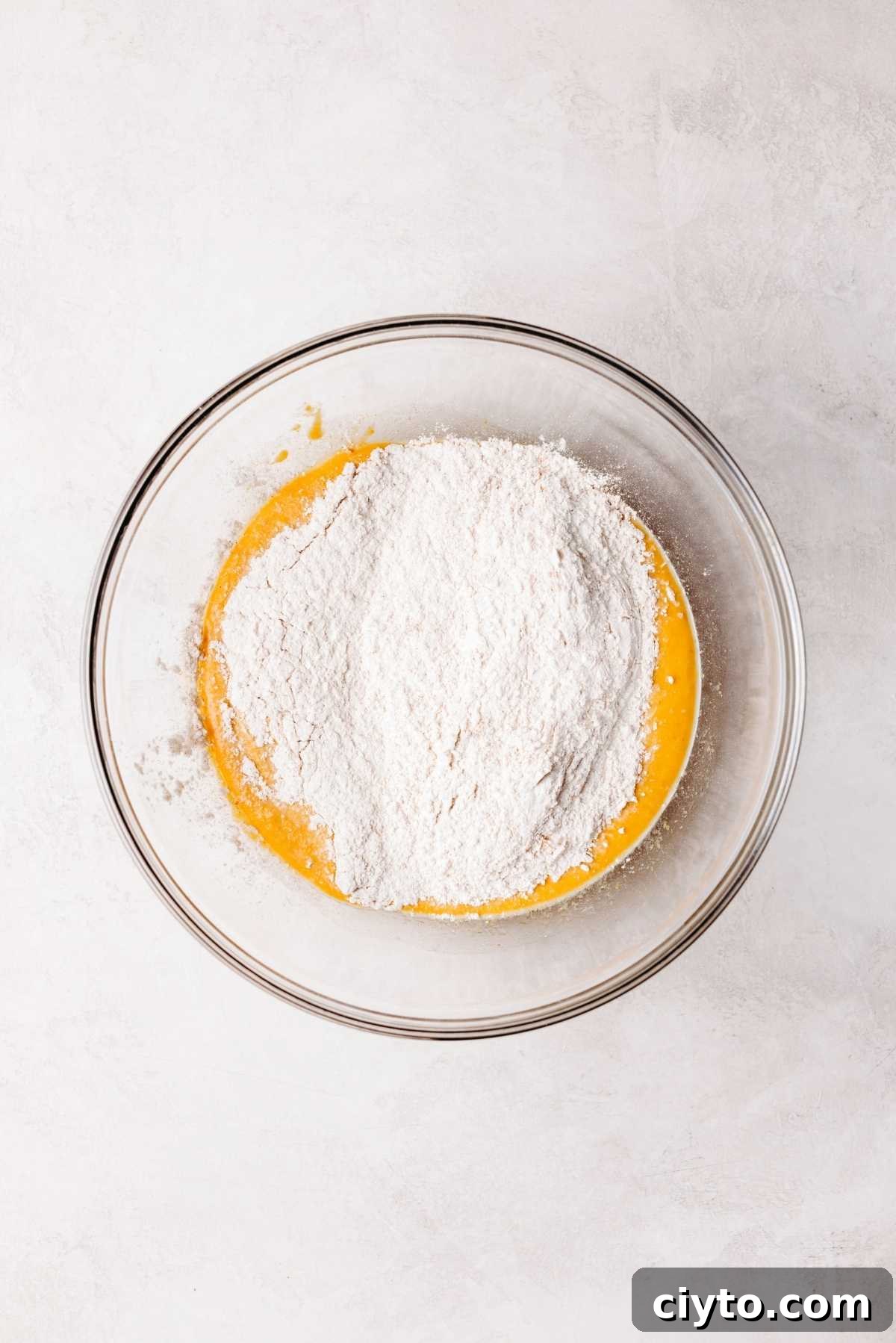 Adding flour mixture to wet ingredients.