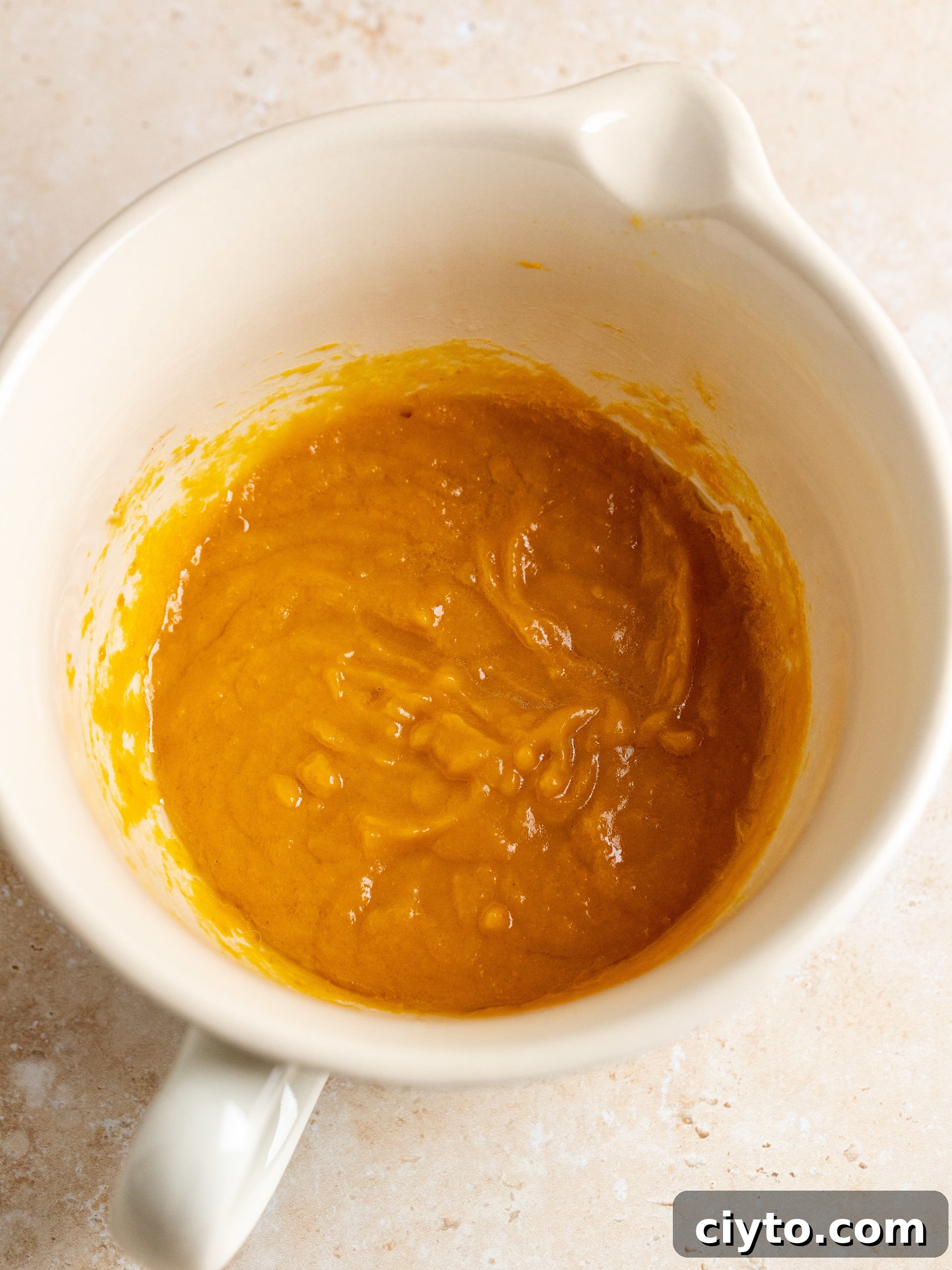 Whisking pumpkin muffin wet ingredients
