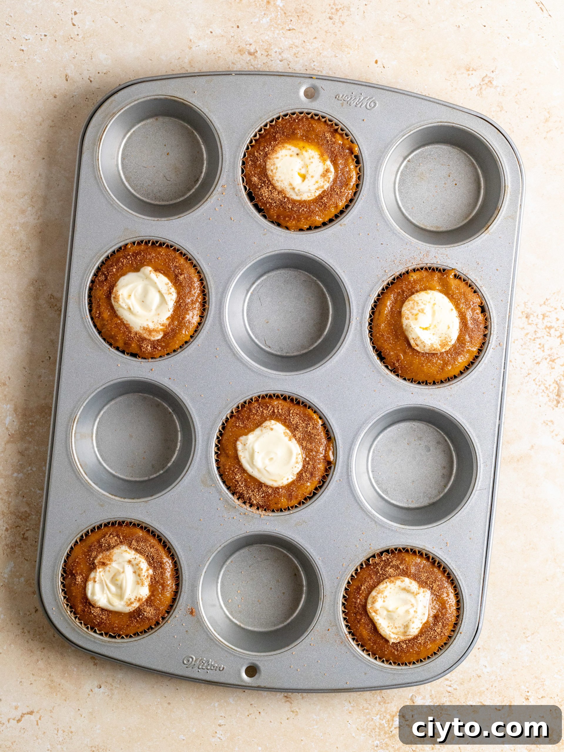 Filling pumpkin muffins with cream cheese