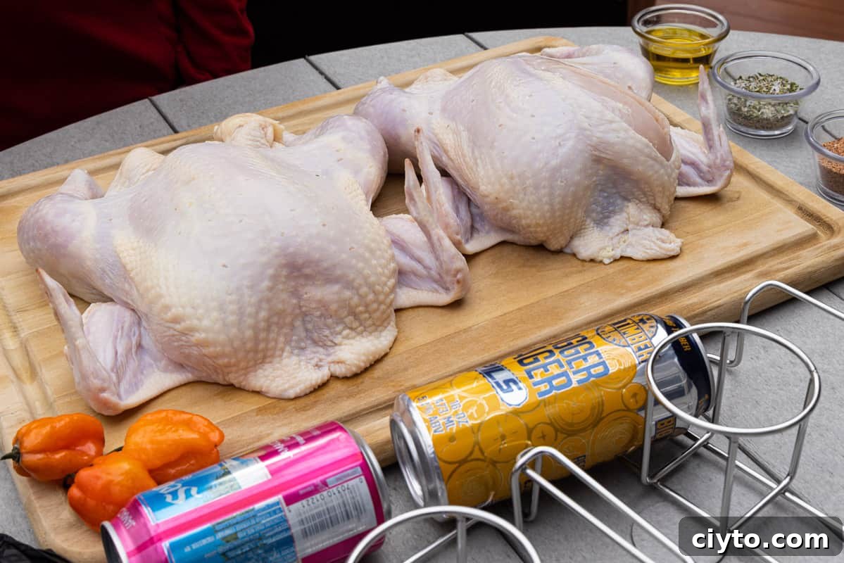 How to Smoke Beer Can Chicken 3 Two raw chickens on cutting board with beer cans and seasoning around the cutting board.
