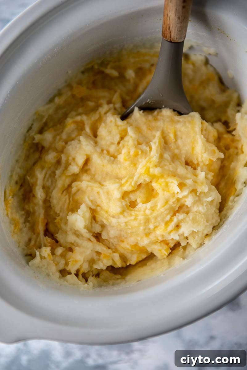 cheesy mashed potatoes in a slow cooker