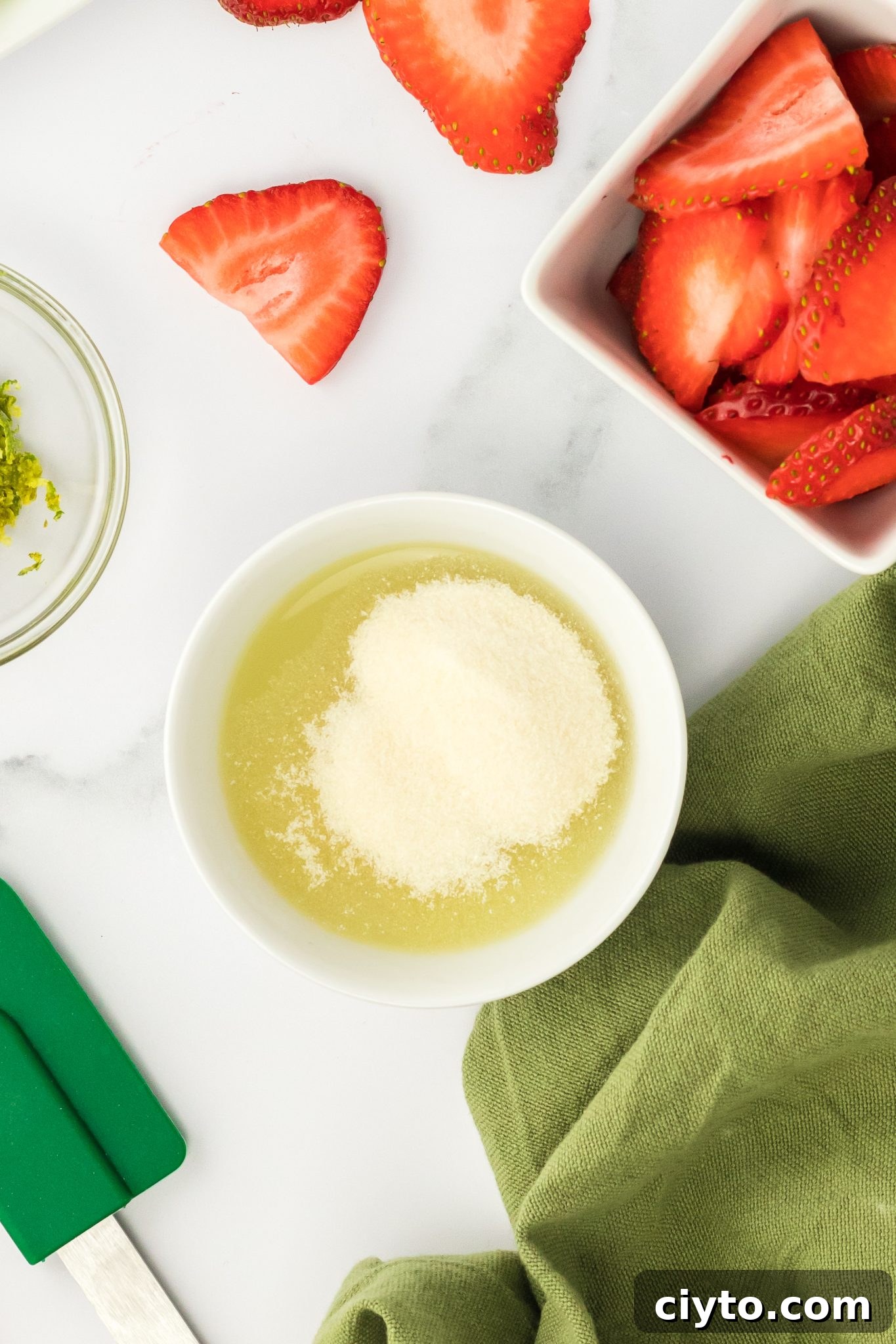 top down view of gelatin and lime juice in a bowl, blooming.