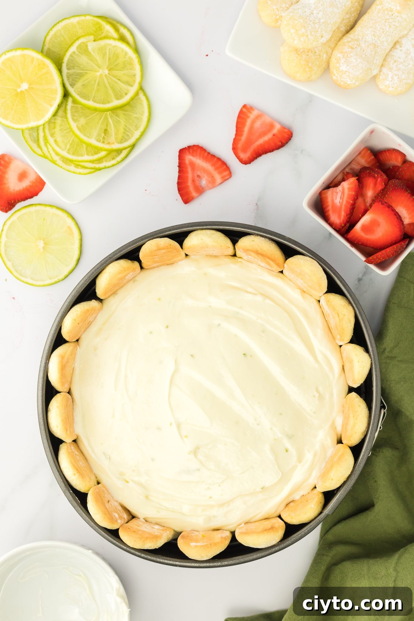 top down view of unbaked lime cheesecake in a pan ready to chill.