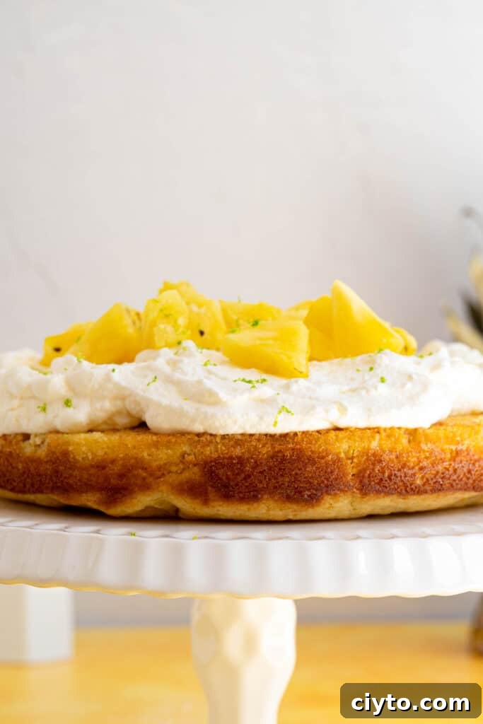 Moist Pina Colada Cake Recipe with Fresh Pineapple 10 a pina colada cake on a platter