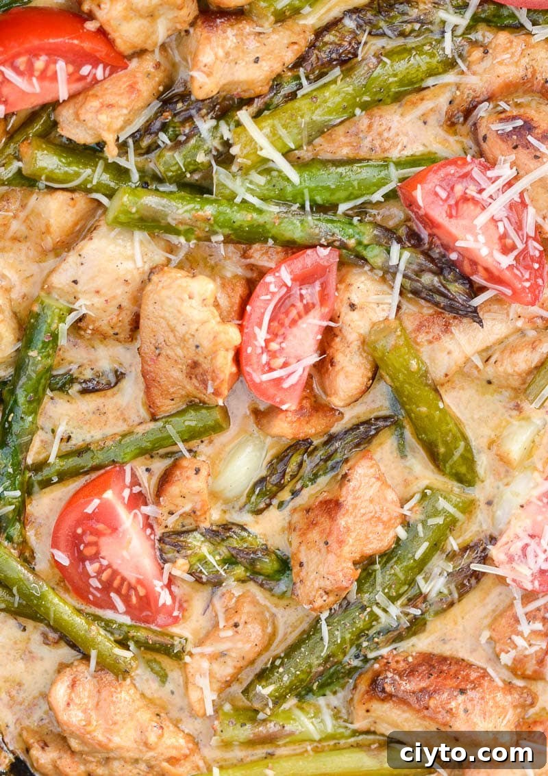 Keto Tuscan Chicken with Asparagus is an easy one pan low carb meal! Packed with seasoned chicken, tender asparagus and a rich parmesan cream sauce this will be a new family favorite!