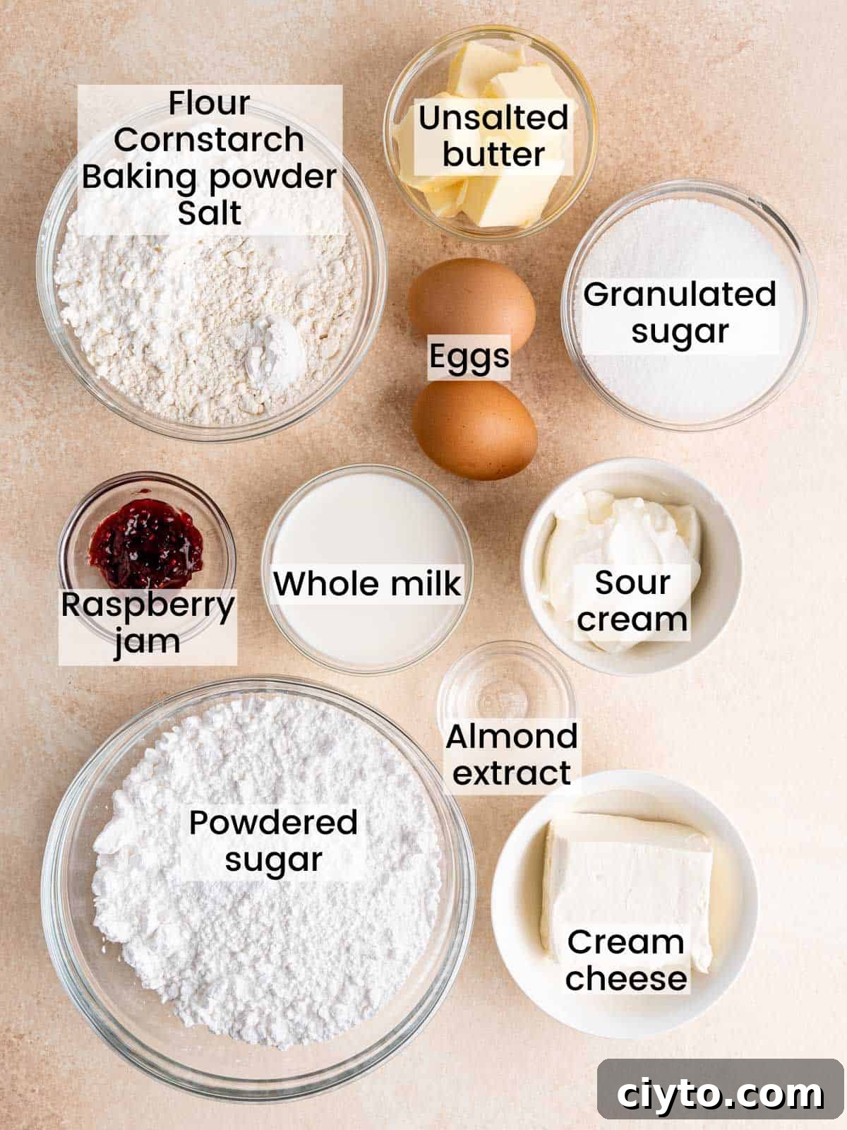 Ingredients needed to make almond cupcakes with raspberry cream cheese frosting.