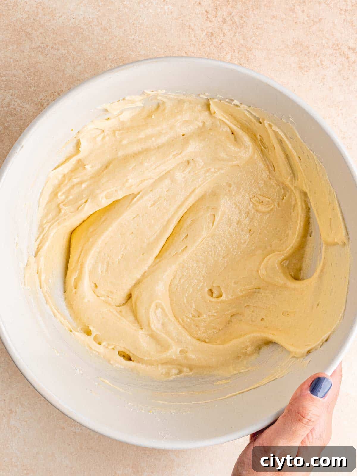 Almond cupcake batter in a bowl.