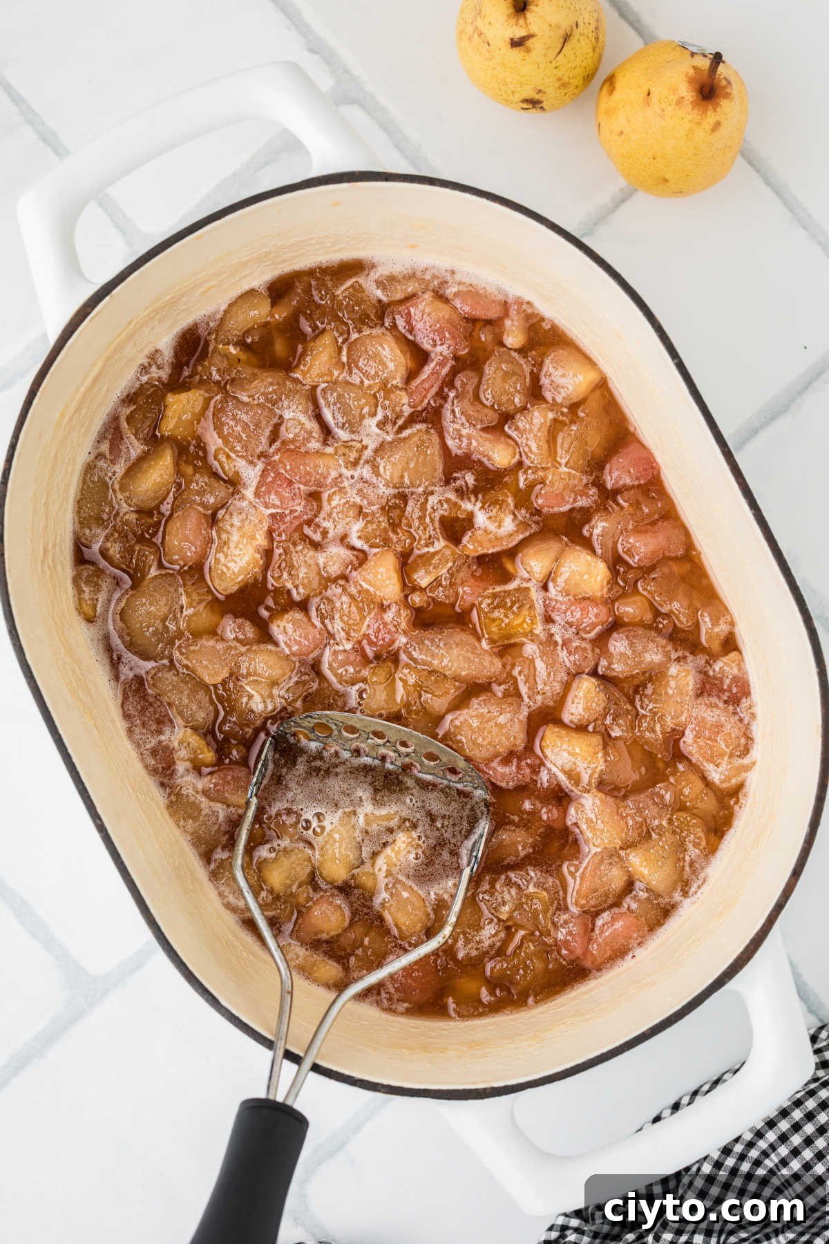 A large pot with pears that have been cooked down.