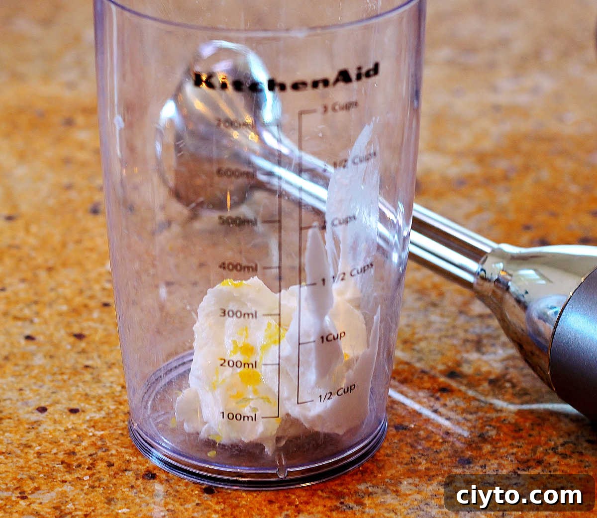 Whipping the cream with lemon and sweetener.