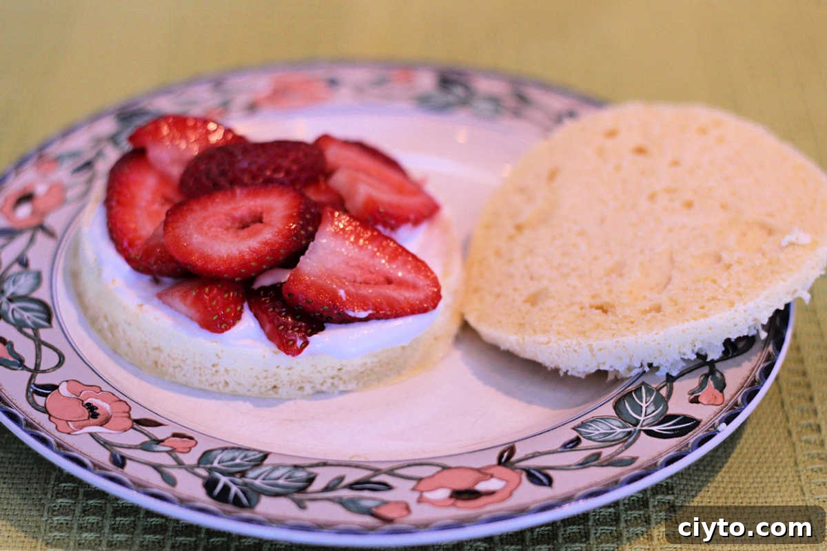 Layering the cream and berries on the shortcake.