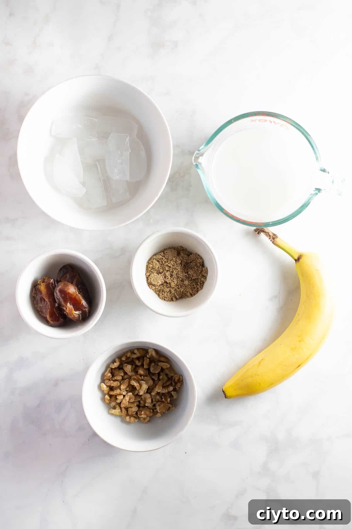 ingredients in white prep bowls to make a banana smoothie recipe