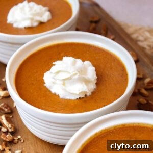 Baked pumpkin custard with whipped cream.