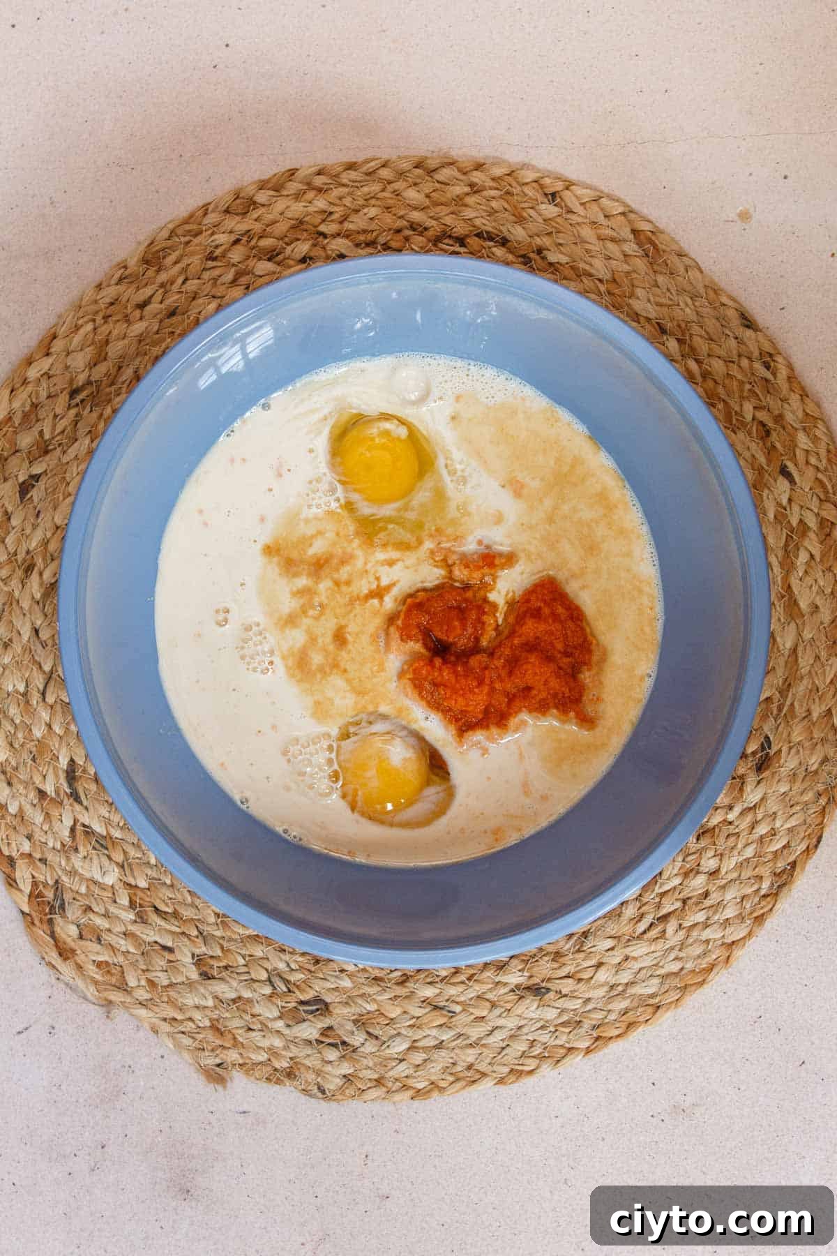 Pumpkin custard wet ingredients in a large mixing bowl.