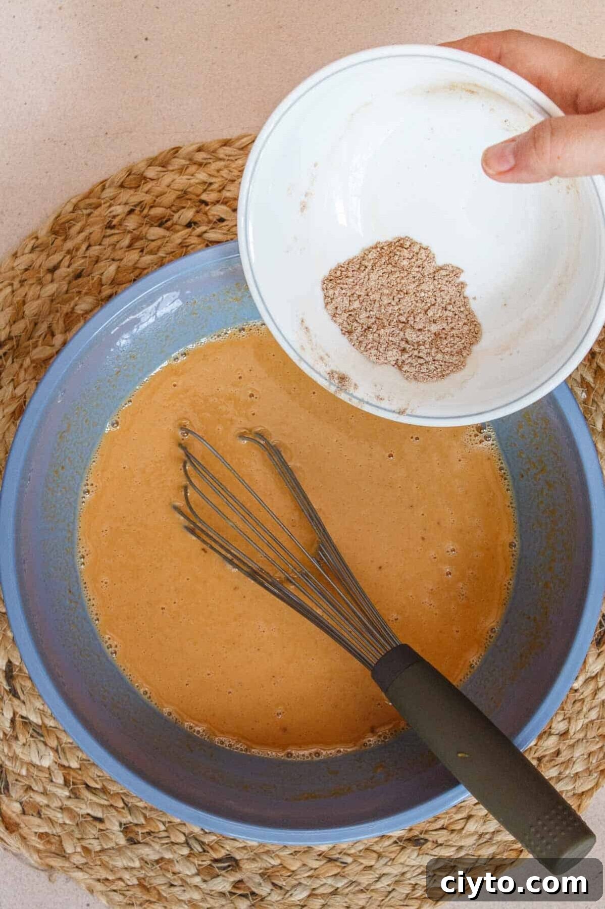 Dry ingredients being added to wet ingredients.