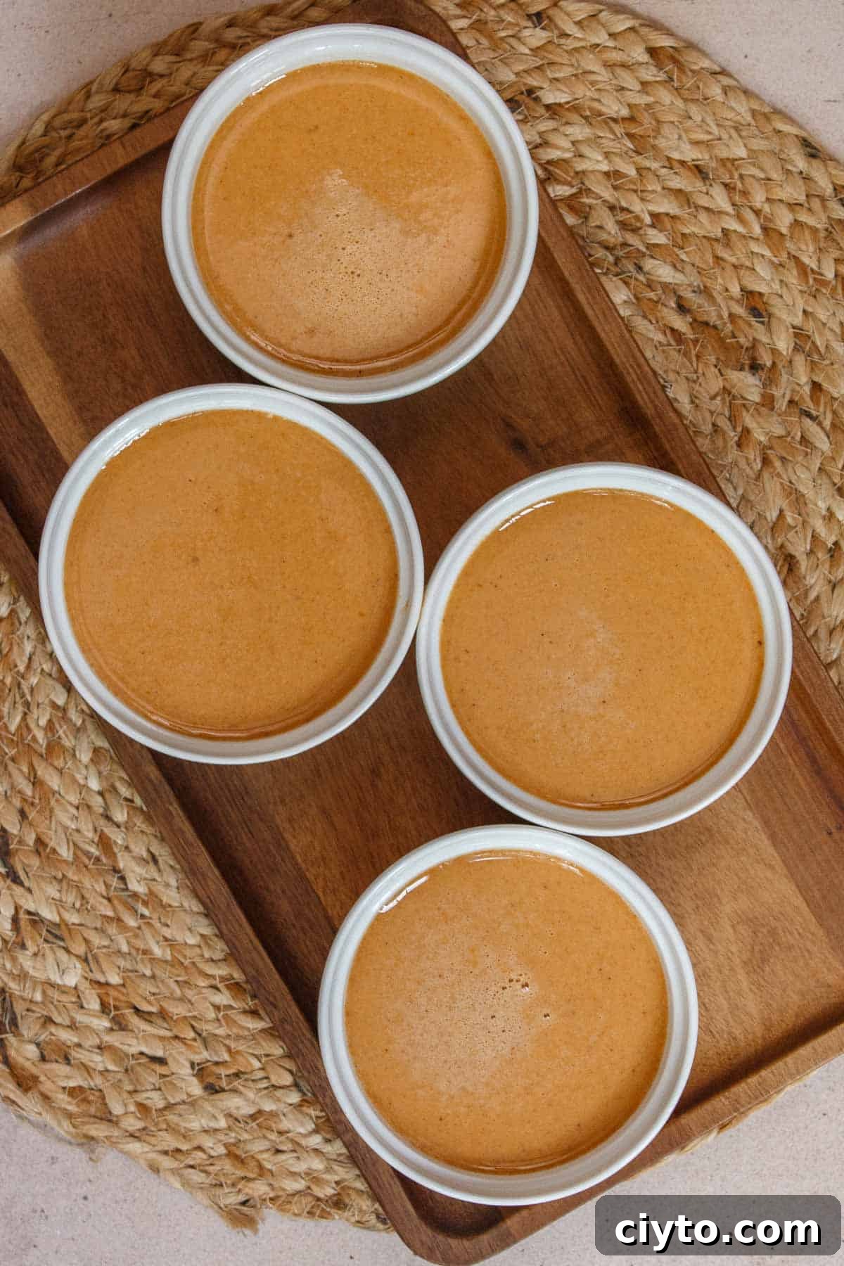 Uncooked pumpkin custard in ramekins.