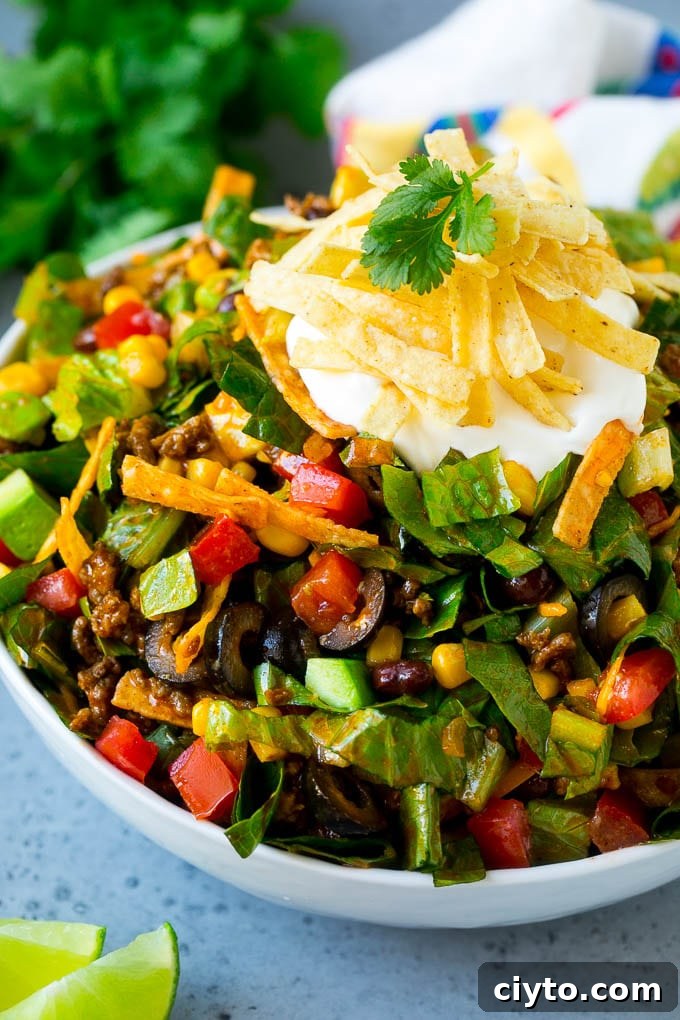 Crispy Taco Salad with Fresh Salsa and Avocado 8 A bowl of taco salad with ground beef, lettuce, tomatoes, cheese and olives.