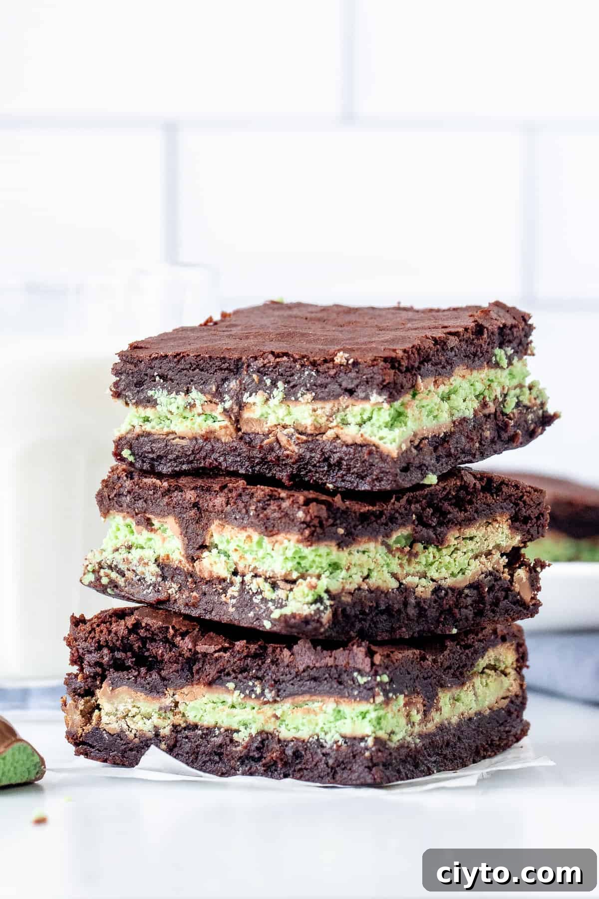 3 Mint Aero brownies with a glass of milk