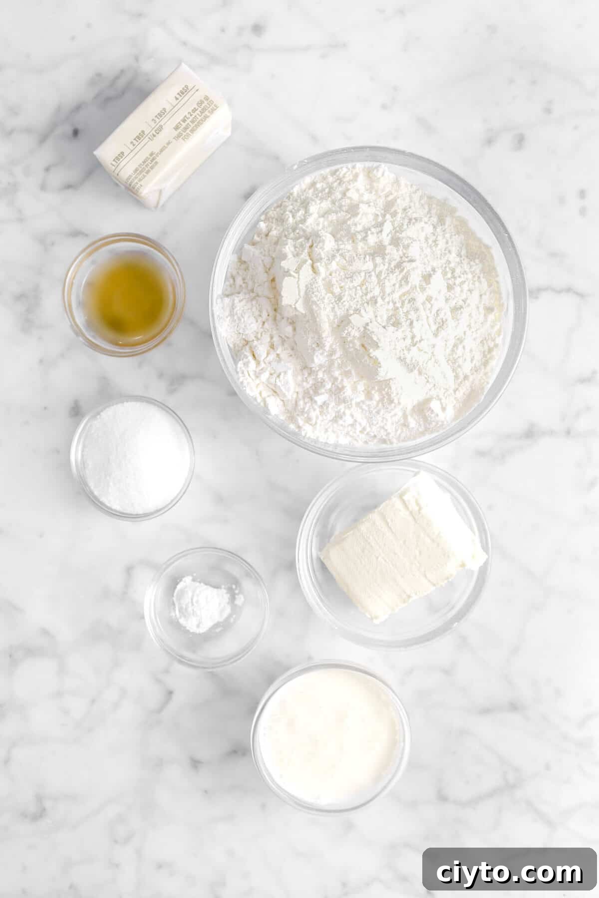 butter, apple cider vinegar, flour, sugar, baking powder, cream cheese, and heavy cream in glass bowls