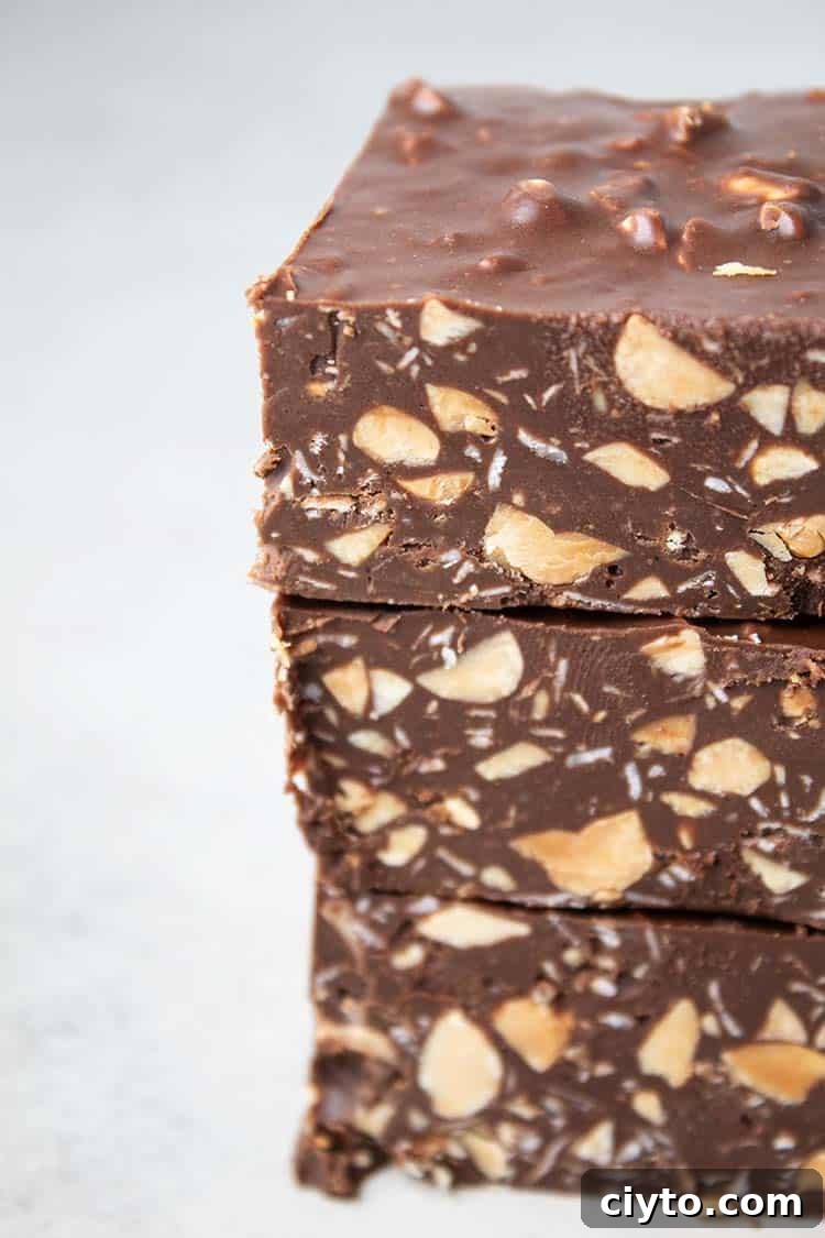 Low-Carb Peanut Butter Crunch Bars, Gluten Free, No Added Sugar 2 sideview of stack of three homemade cruch bars that are low carb, sugar free, gluten free, keto and healthy on a white background