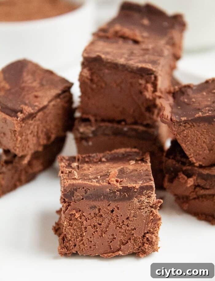Low-Carb Peanut Butter Crunch Bars, Gluten Free, No Added Sugar 6 keto chocolate dessert on a white plate in front of almond milk and cocoa powder in a white bowl