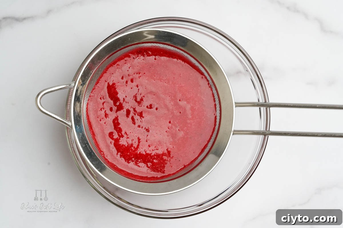 Vodka Spritzer with Homemade Cranberry Syrup 5 straining the blended cranberry mixture through a mesh strainer