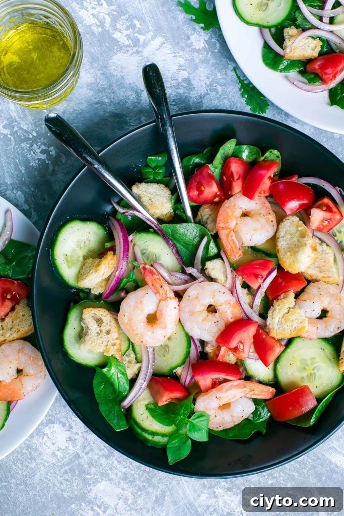 Shrimp Spinach Salad with tomatoes, cucumber, basil, red onion, and croutons