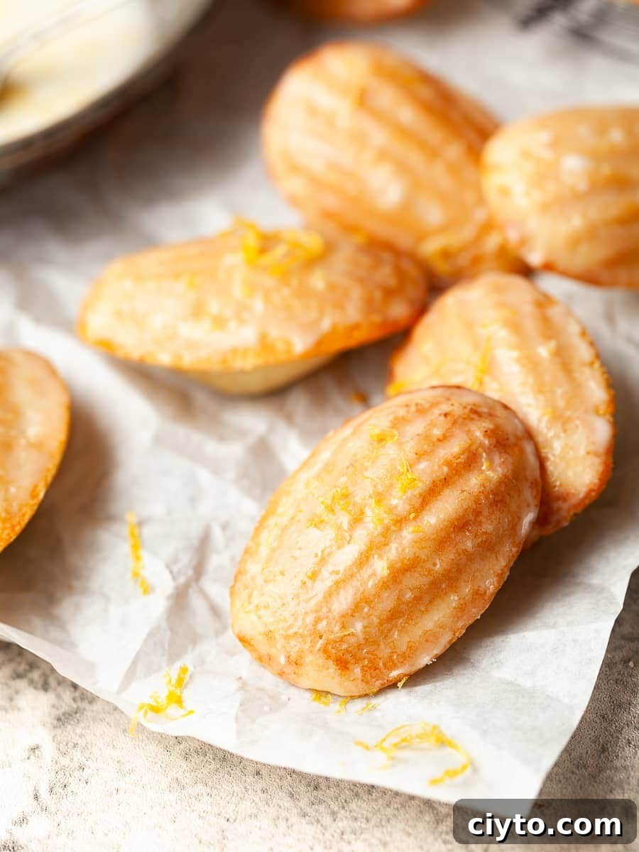 lemon madeleines topped with a lemon glaze and lemon zest