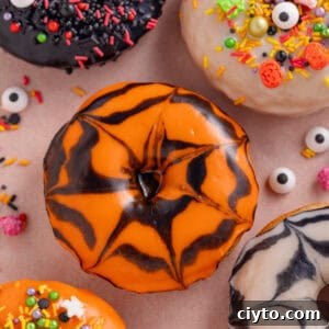 Gluten free baked doughnuts with halloween icing and sprinkles.