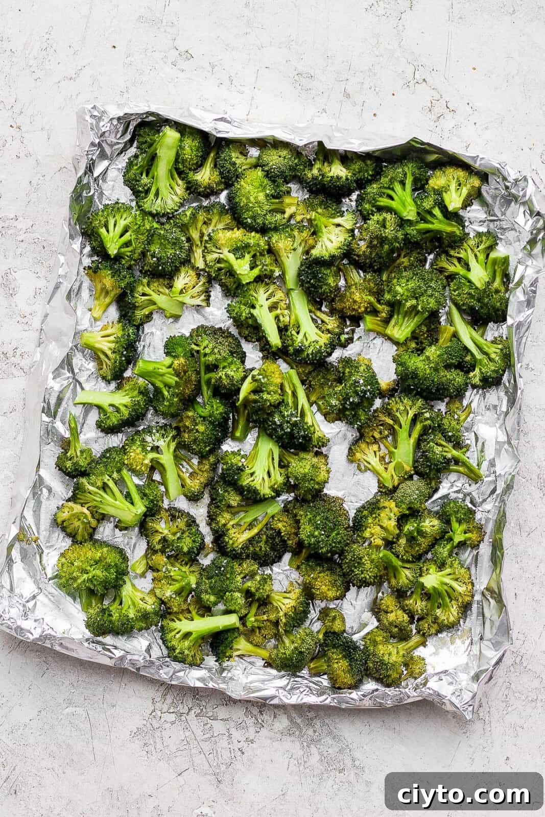 Smoked broccoli in an aluminum foil boat.