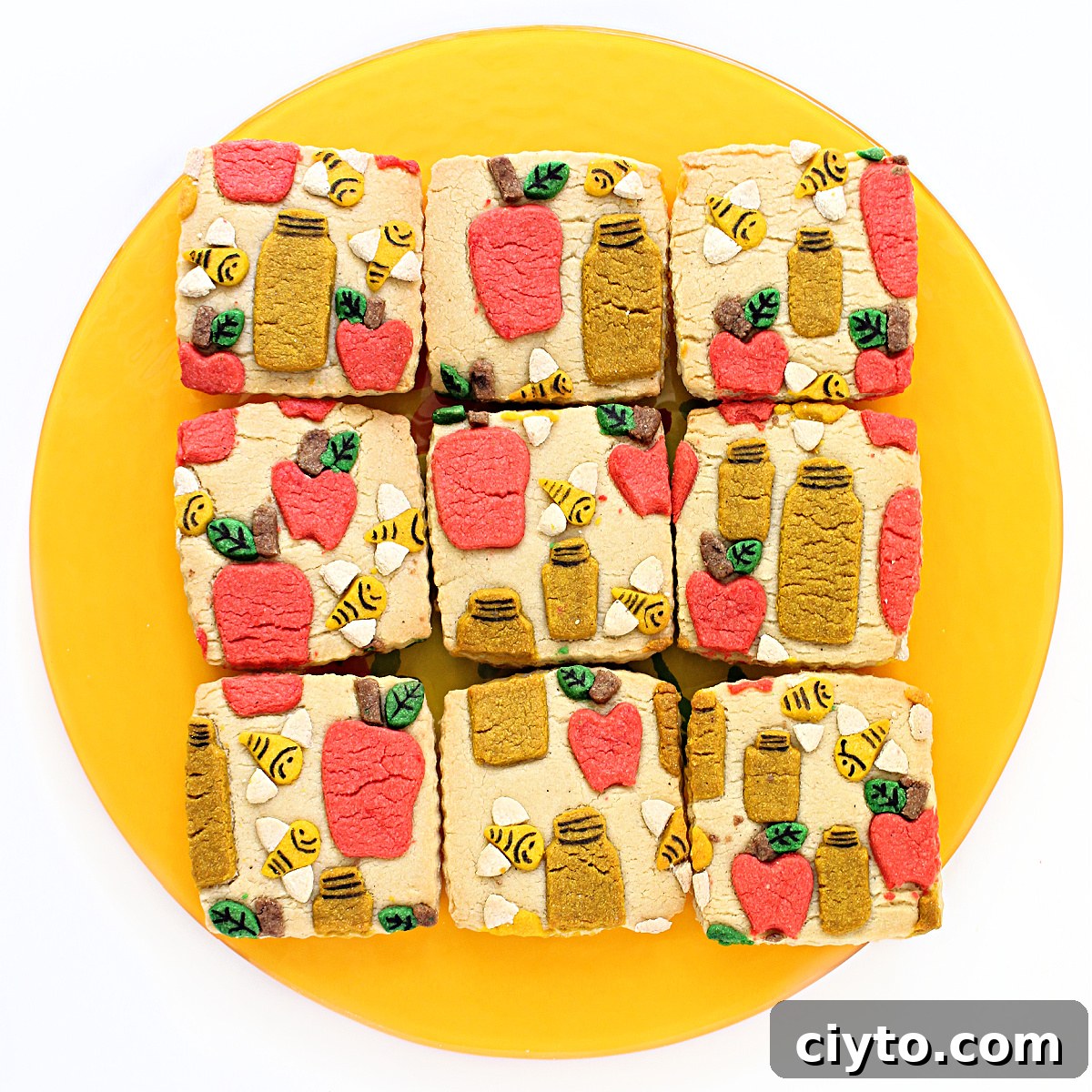 Rosh Hashanah Patterned Cookies: Creative Designs and Ideas 8 Square sugar cookies decorated with cutout bees, apples, and honey jars.