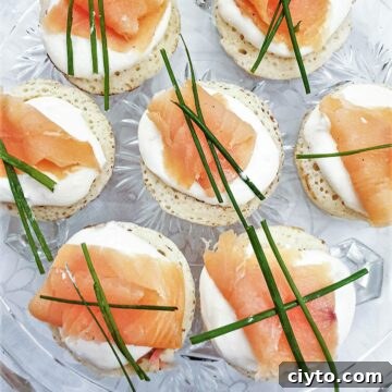 Closeup of blinis topped with creamy horesradish and smoked salmon.