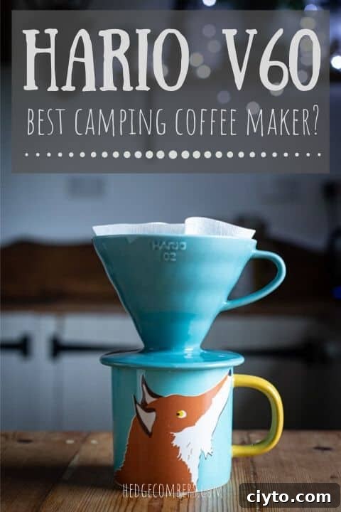 a turquoise hario v60 drip coffee maker sat on a cute fox cup in a dark kitchen